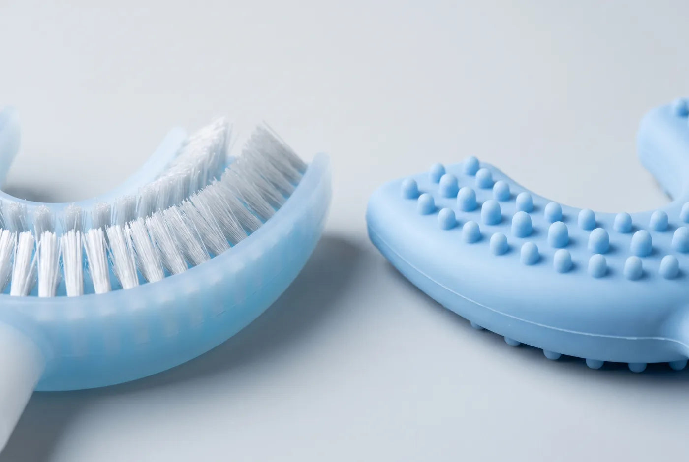 Macro comparison of soft nylon bristles beside a silicone-nub brush head