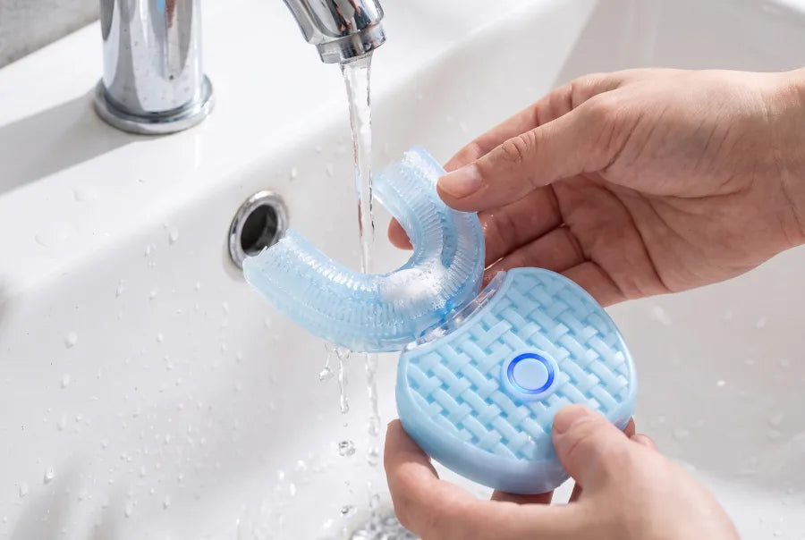 Rinsing the brush head under a running tap